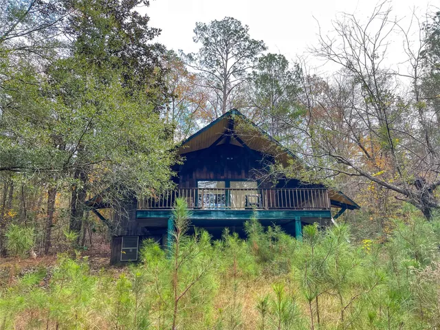 a wooden bench sitting in front of a house