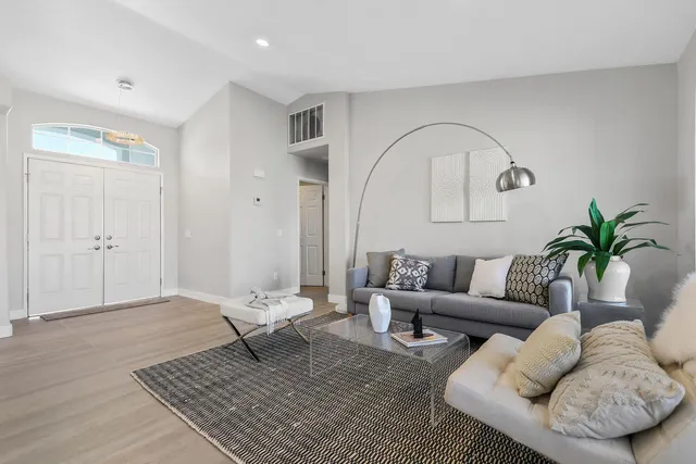 a living room with furniture and a potted plant