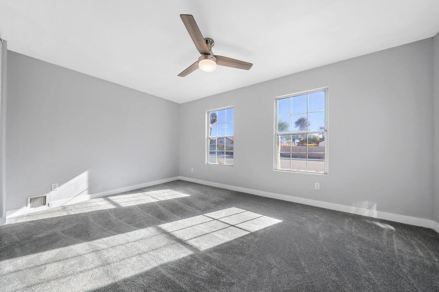 Undisclosed Address Palm Desert, CA 92211 - Photo 13 of 31 a view of a big room with windows and ceiling fan