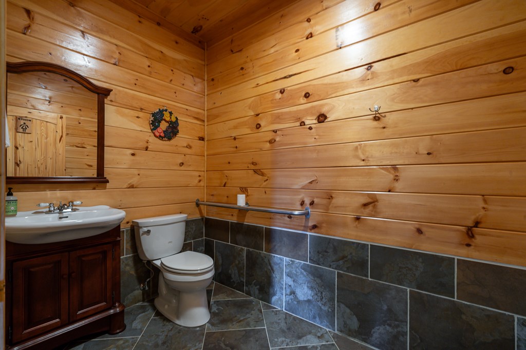 540 Plemons Road Chatsworth, GA 30705 - Photo 57 of 62 a bathroom with a toilet sink and mirror