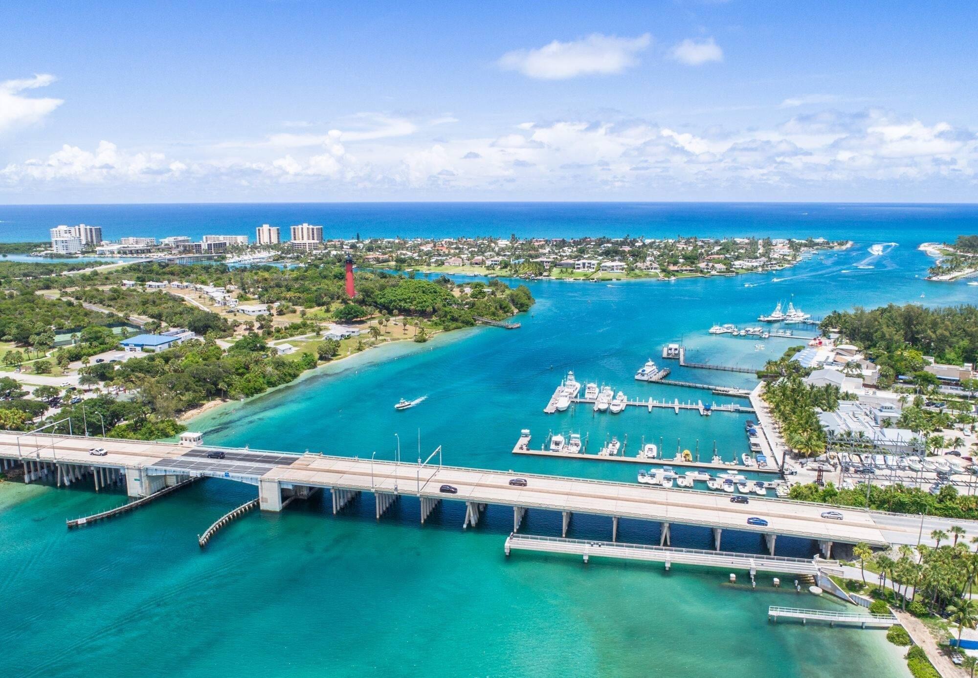 102 Lighthouse Drive Jupiter Inlet Colony, FL 33469 - Photo 15 of 18 an aerial view of a city with lots of residential buildings ocean and mountain view in back