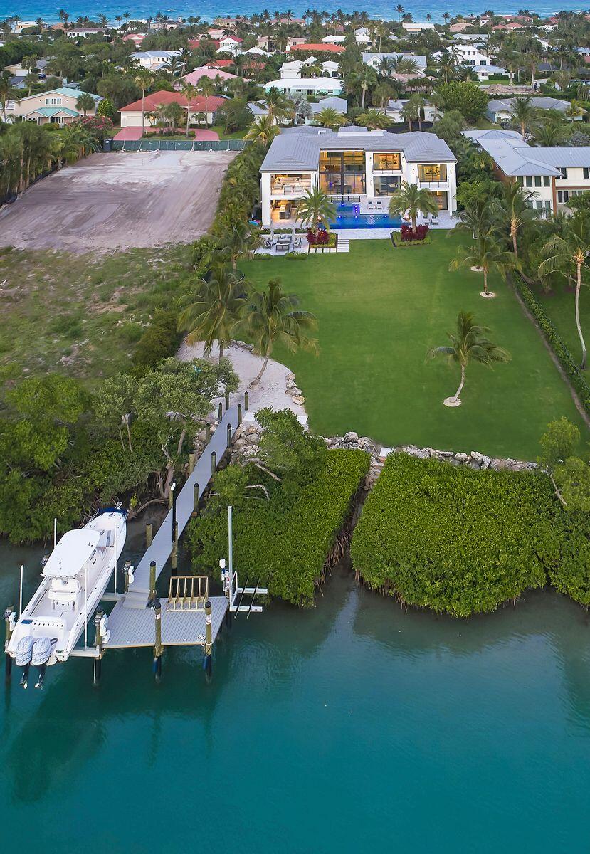 102 Lighthouse Drive Jupiter Inlet Colony, FL 33469 - Photo 3 of 18 an aerial view of a house with a garden and lake view