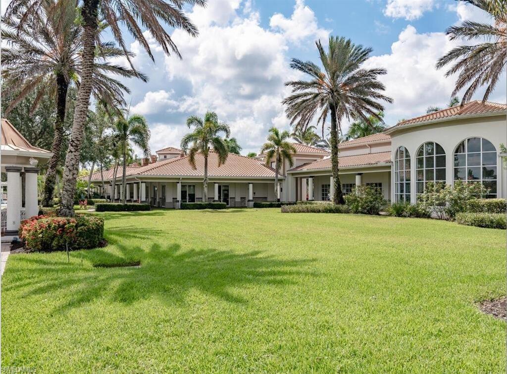 5477 Freeport Lane Naples, FL 34119 - Photo 35 of 36 a front view of a house with a garden