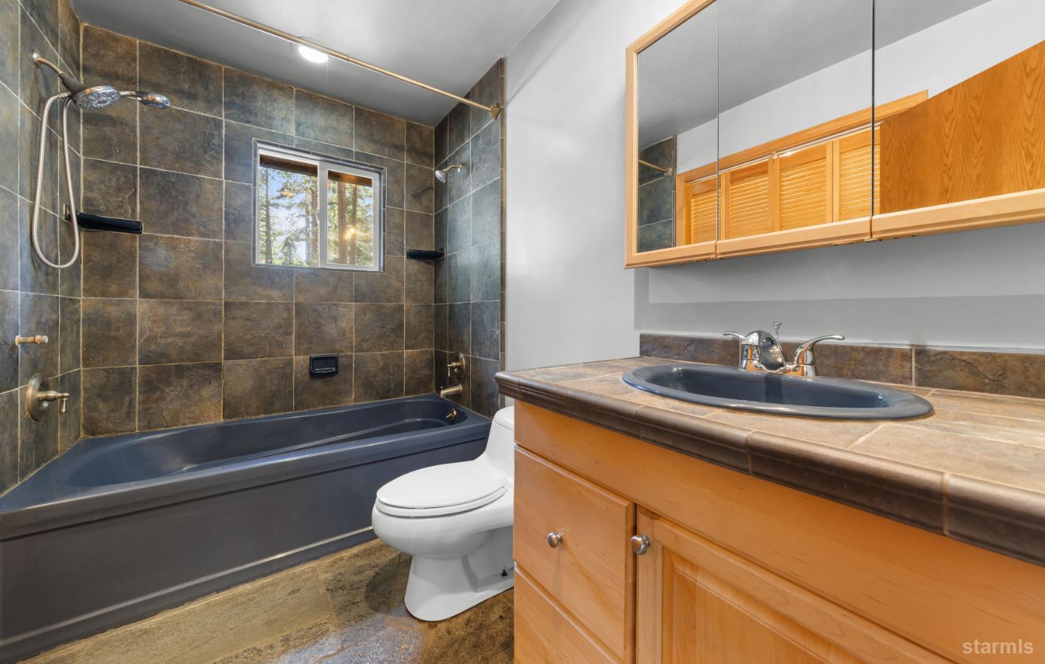 712 Seneca Drive South Lake Tahoe, CA 96150 - Photo 12 of 28 a bathroom with a sink a toilet and shower