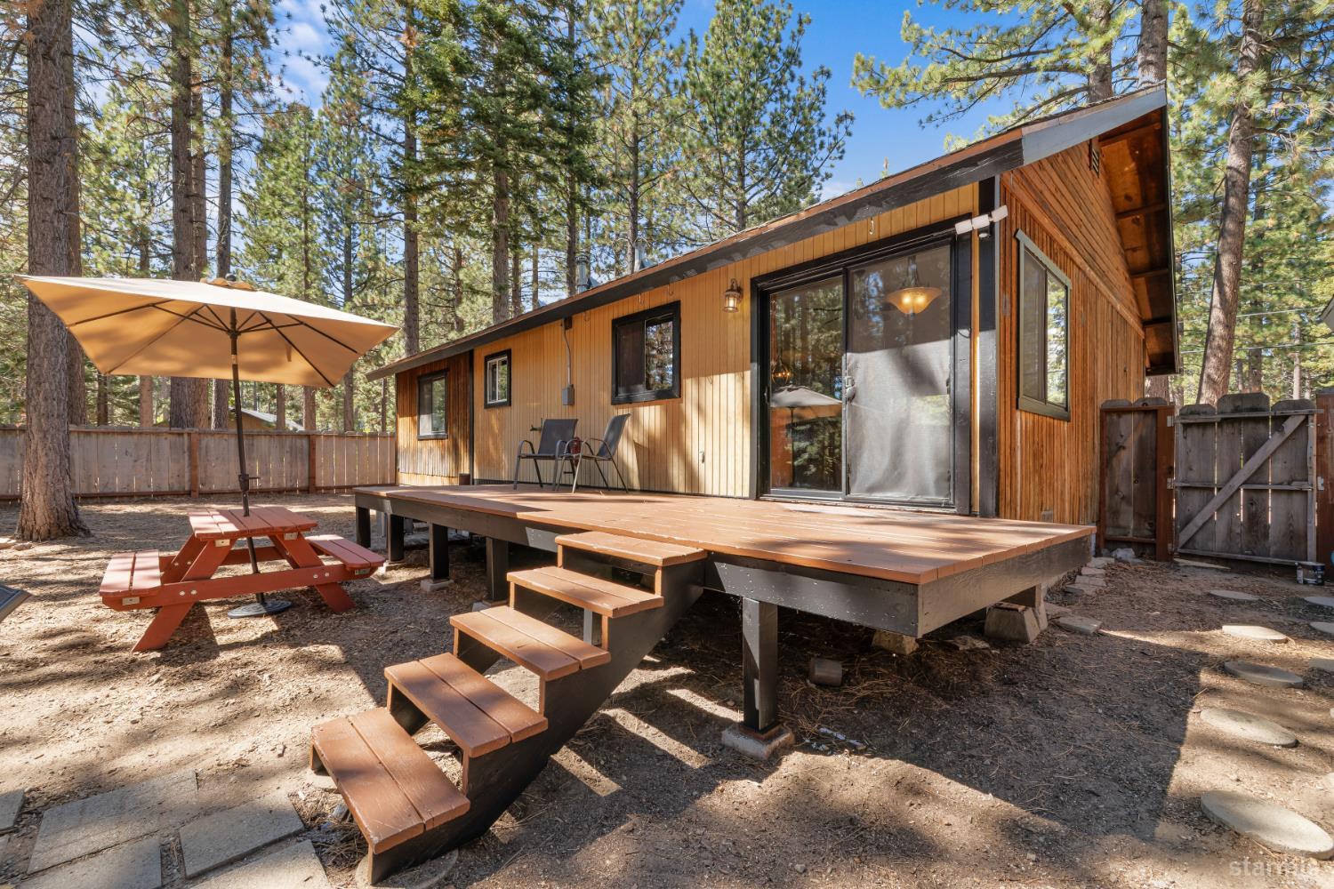 712 Seneca Drive South Lake Tahoe, CA 96150 - Photo 15 of 28 a backyard of a house with barbeque oven table and chairs
