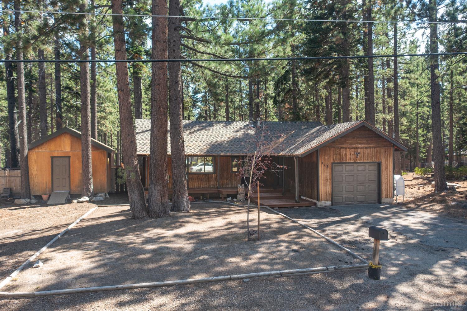 712 Seneca Drive South Lake Tahoe, CA 96150 - Photo 23 of 28 a wooden house with trees in front of it