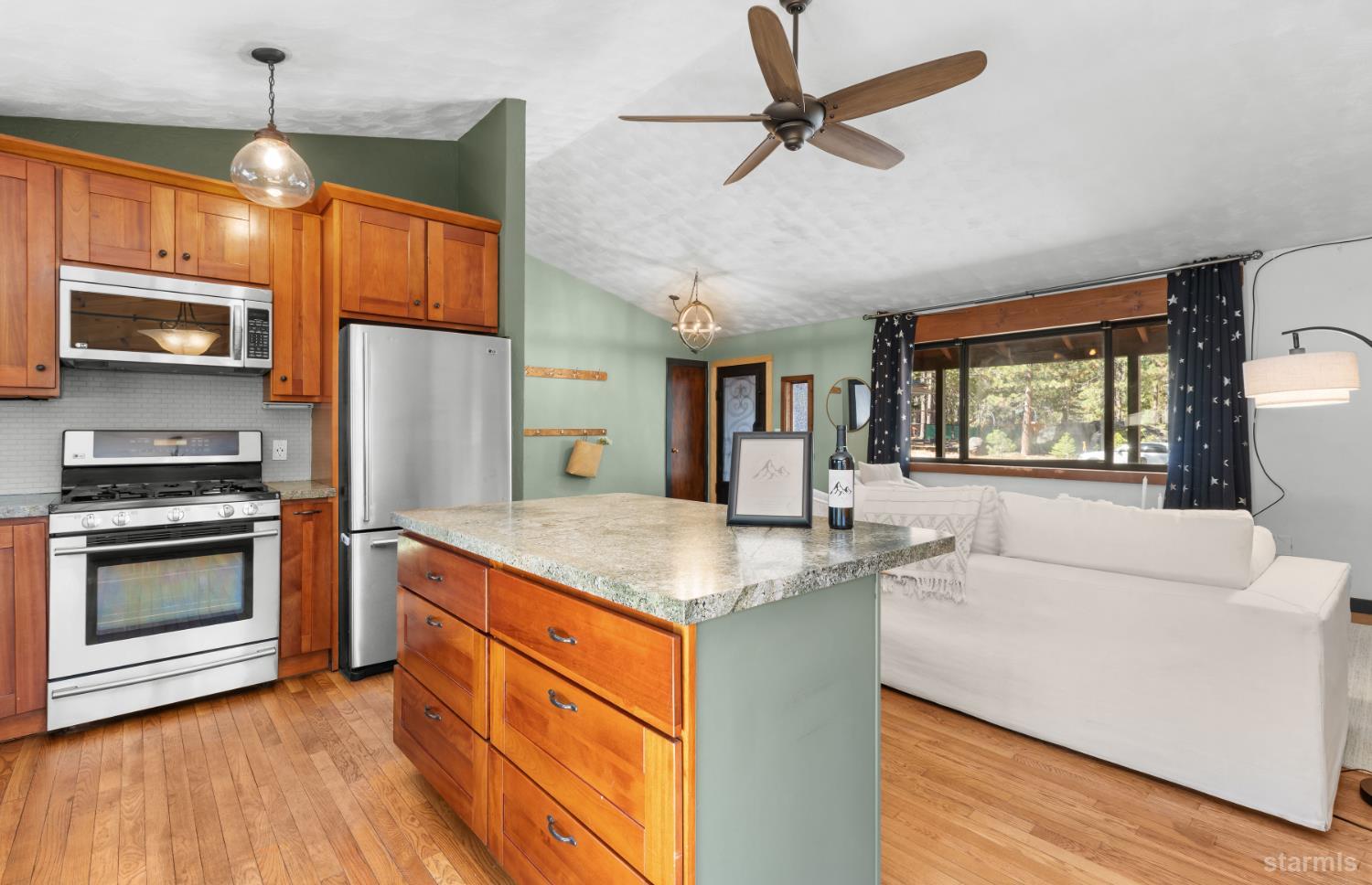712 Seneca Drive South Lake Tahoe, CA 96150 - Photo 9 of 28 a kitchen with stainless steel appliances granite countertop a stove and a refrigerator