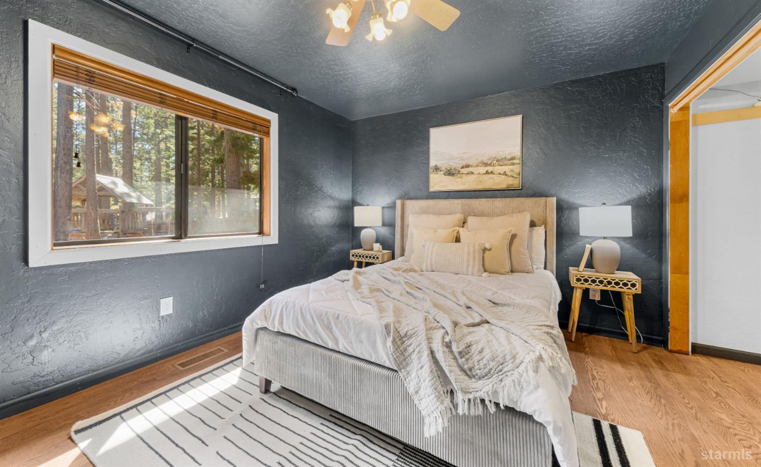 712 Seneca Drive South Lake Tahoe, CA 96150 - Photo 10 of 28 a bedroom with a large bed and a window