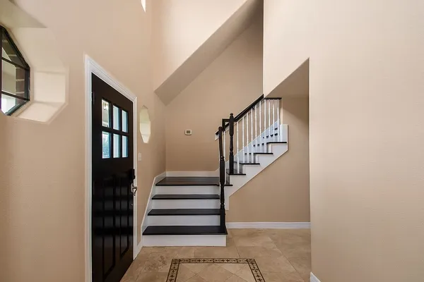 a large space with a large window and stainless steel appliances