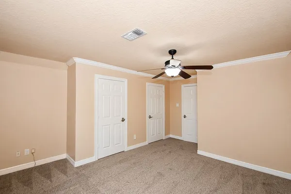 an empty room with a fan