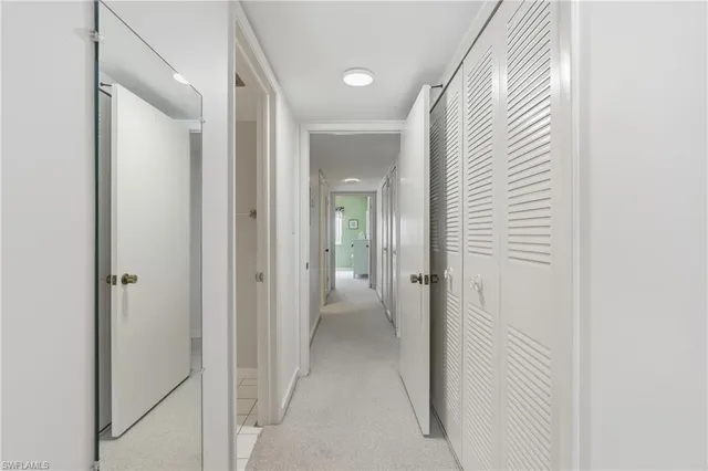 a view of a hallway with wooden shelves