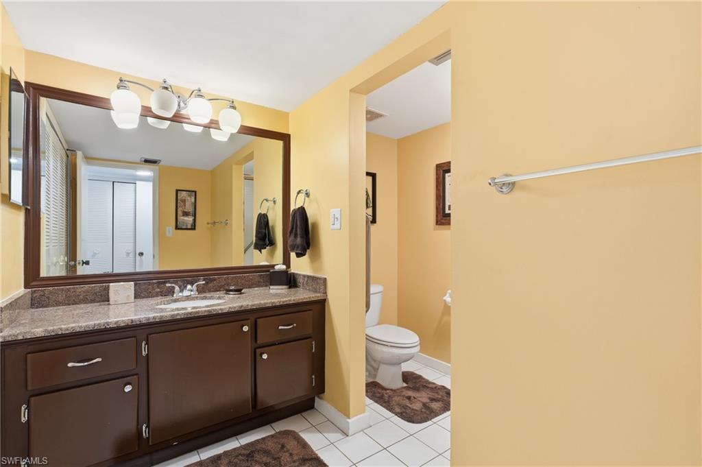 215 Cypress Way East, Unit D8 Naples, FL 34110 - Photo 12 of 20 Bathroom featuring vanity and light tile patterned flooring