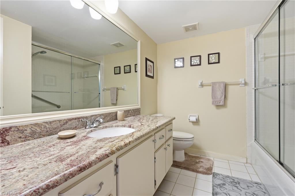 215 Cypress Way East, Unit D8 Naples, FL 34110 - Photo 14 of 20 Full bath featuring light tile patterned floors and vanity