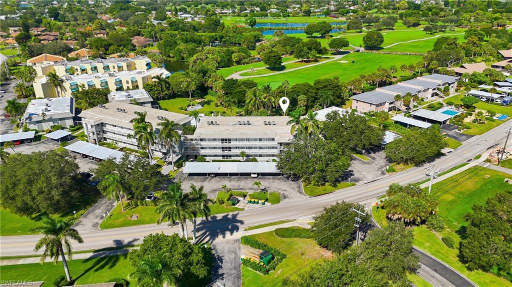 215 Cypress Way East, Unit D8 Naples, FL 34110 - Photo 17 of 20 Aerial overview of property's location with a large body of water and a local golf course