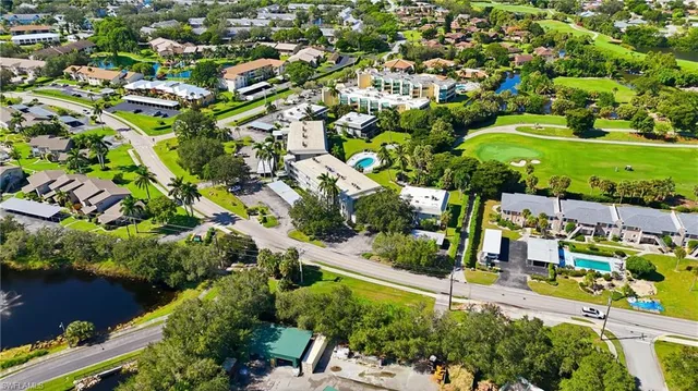 an aerial view of residential houses with outdoor space and street view