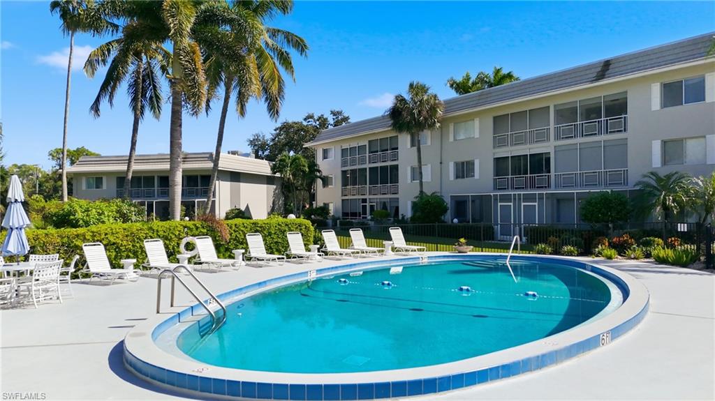 215 Cypress Way East, Unit D8 Naples, FL 34110 - Photo 19 of 20 Community pool with a patio area