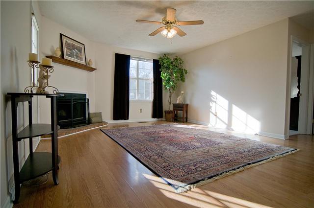 108 River Bend Road Hendersonville, TN 37075 - Photo 3 of 20 Living Room with laminate wood floor, Ceiling Fan and Wood burning Fireplace.