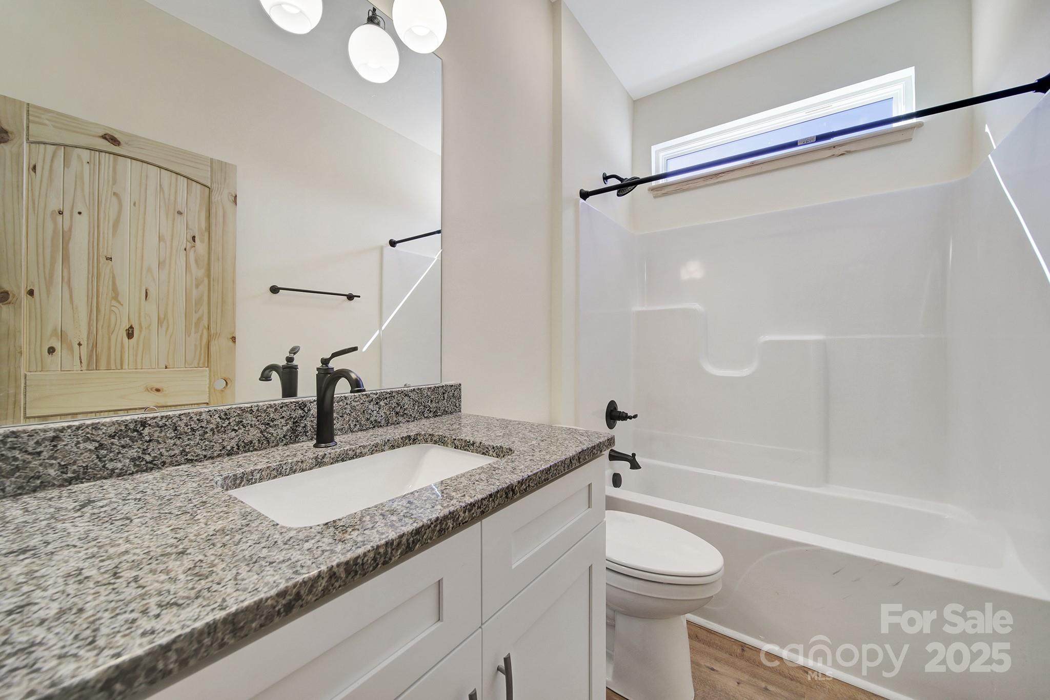 230 East Doc Garris Road Lancaster, SC 29720 - Photo 23 of 31 a bathroom with a granite countertop sink toilet and shower