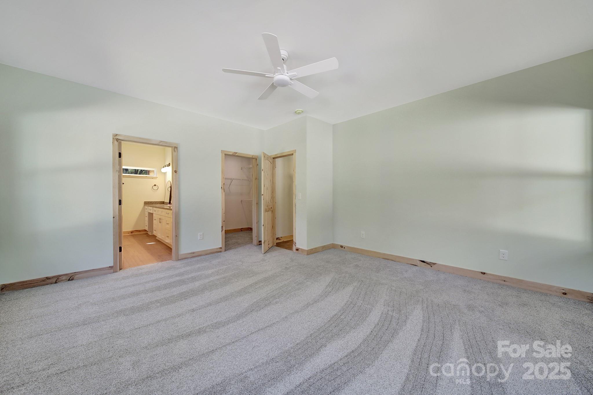 230 East Doc Garris Road Lancaster, SC 29720 - Photo 27 of 31 a view of an empty room with wooden floor and a ceiling fan