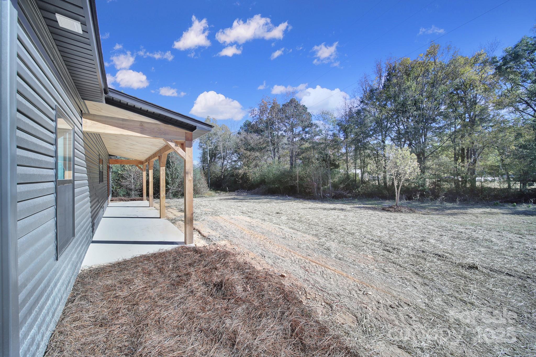 230 East Doc Garris Road Lancaster, SC 29720 - Photo 30 of 31 a view of a house with backyard and trees