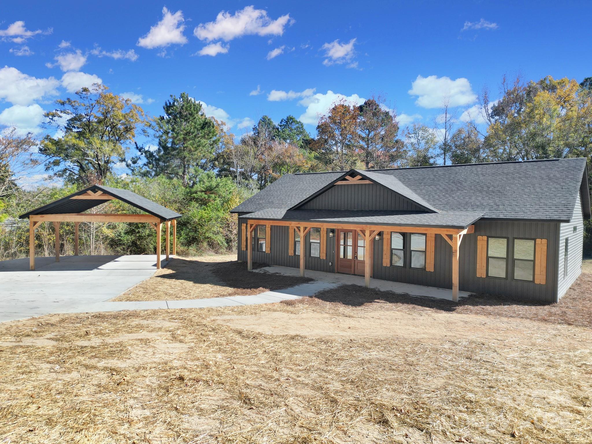 230 East Doc Garris Road Lancaster, SC 29720 - Photo 3 of 31 a front view of a house with a yard and garage
