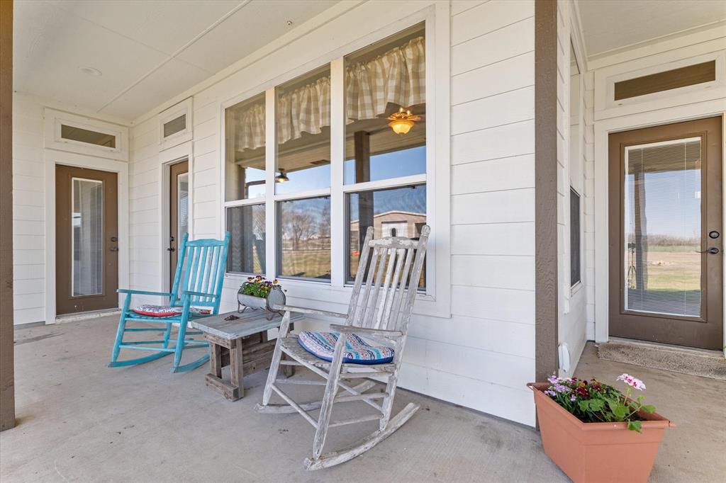 2885 Enloe Road Howe, TX 75459 - Photo 34 of 39 a porch with a bench and chairs