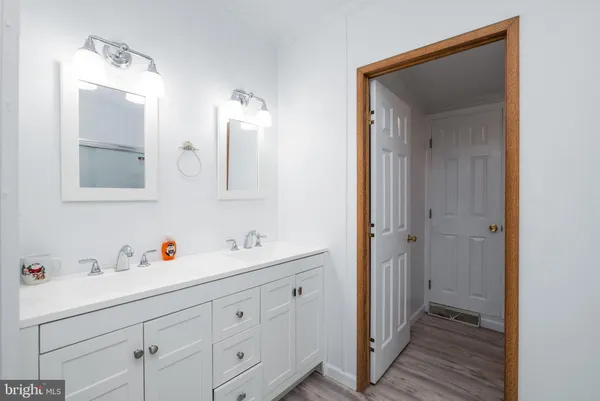 a spacious bathroom with a double vanity sink mirror and