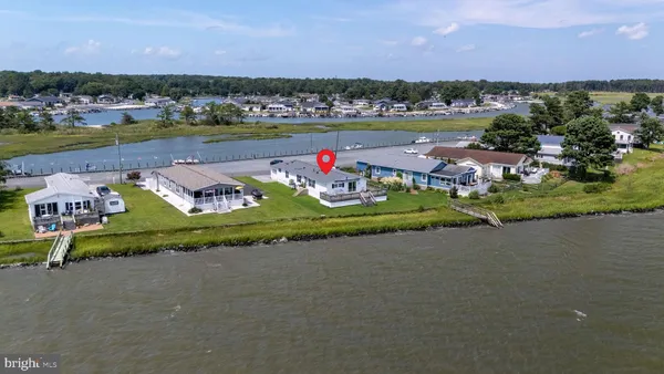 an aerial view of lake and residential houses with outdoor space
