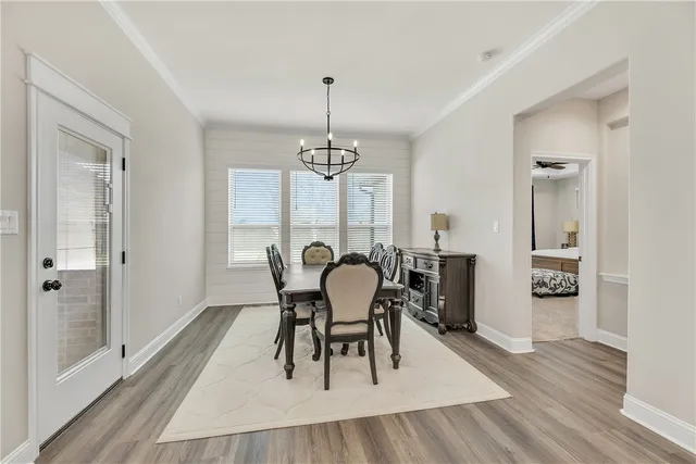 a spacious bedroom with a bed a couch and a ceiling fan