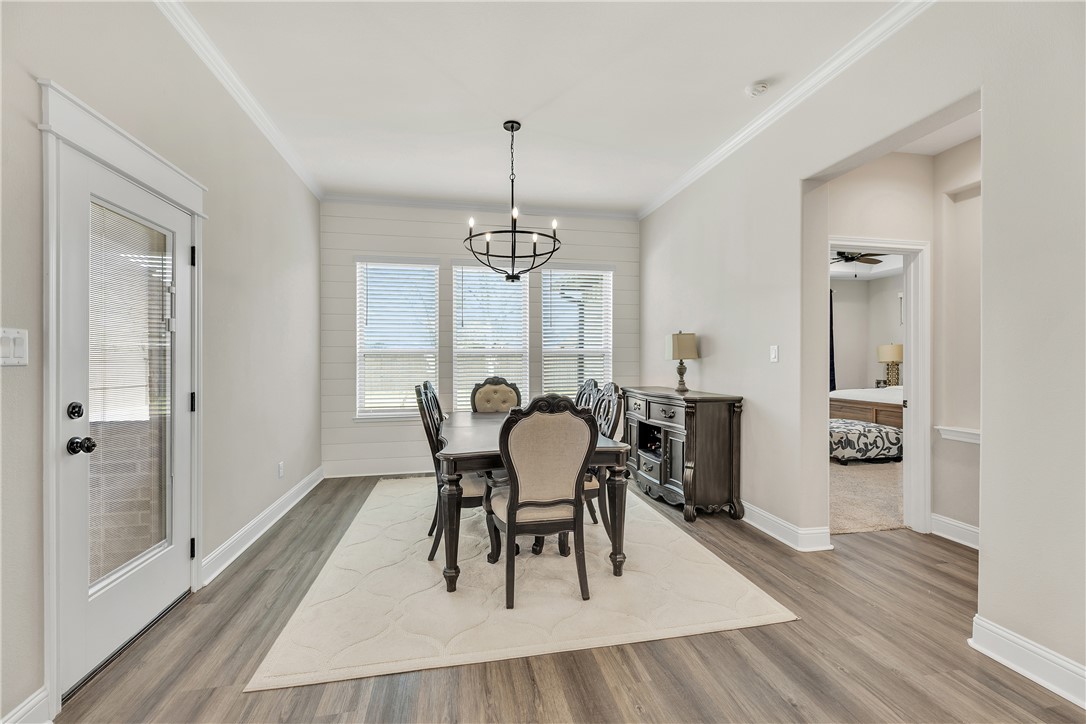 4355 Fox River Lane Bryan, TX 77802 - Photo 12 of 36 a view of a dining room with furniture and wooden floor