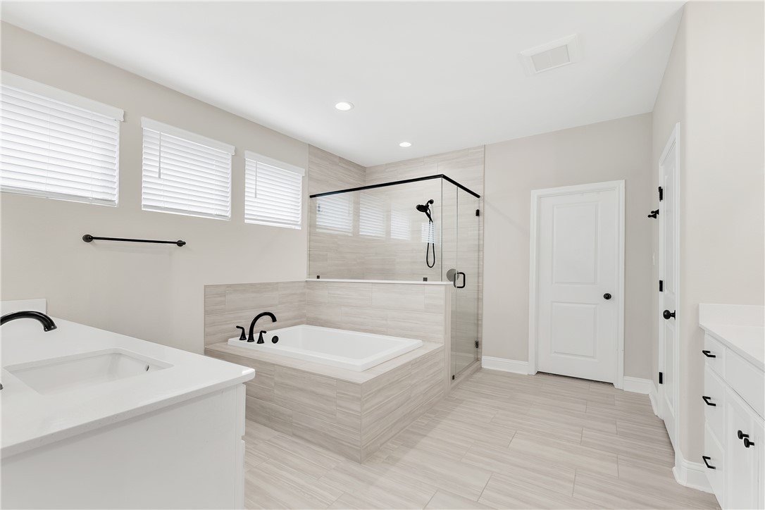 4355 Fox River Lane Bryan, TX 77802 - Photo 15 of 36 a spacious bathroom with a tub sink and mirror