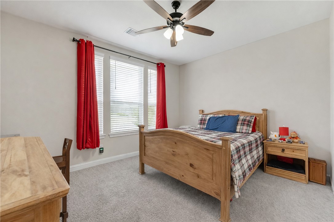 4355 Fox River Lane Bryan, TX 77802 - Photo 17 of 36 a bedroom with a bed and a chandelier