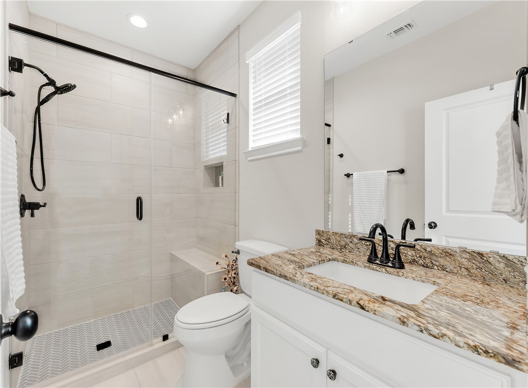 4355 Fox River Lane Bryan, TX 77802 - Photo 21 of 36 a bathroom with a granite countertop sink toilet and shower
