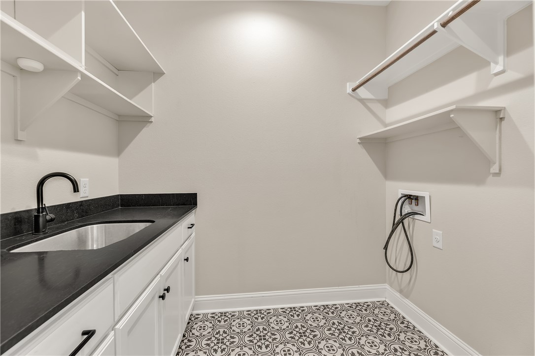 4355 Fox River Lane Bryan, TX 77802 - Photo 23 of 36 a bathroom with a granite countertop sink a toilet and vanity