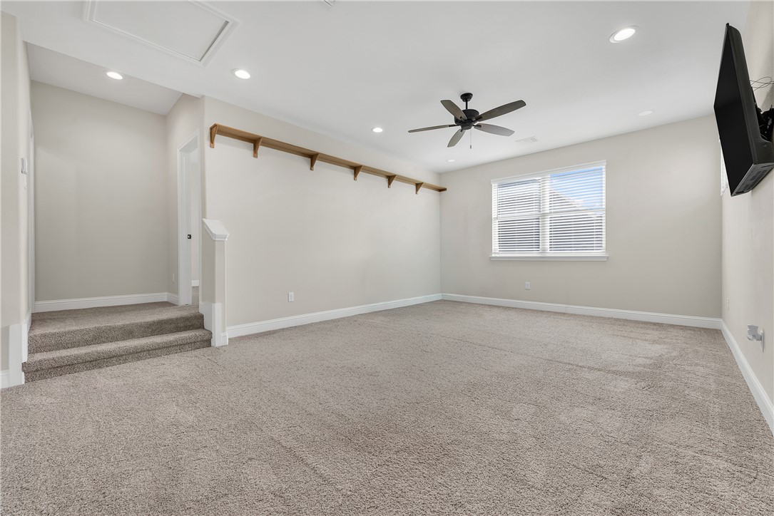 4355 Fox River Lane Bryan, TX 77802 - Photo 26 of 36 an empty room with windows and ceiling fan