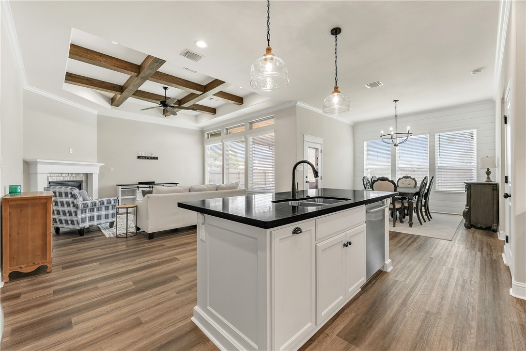 4355 Fox River Lane Bryan, TX 77802 - Photo 7 of 36 a kitchen with granite countertop a sink appliances and wooden floor