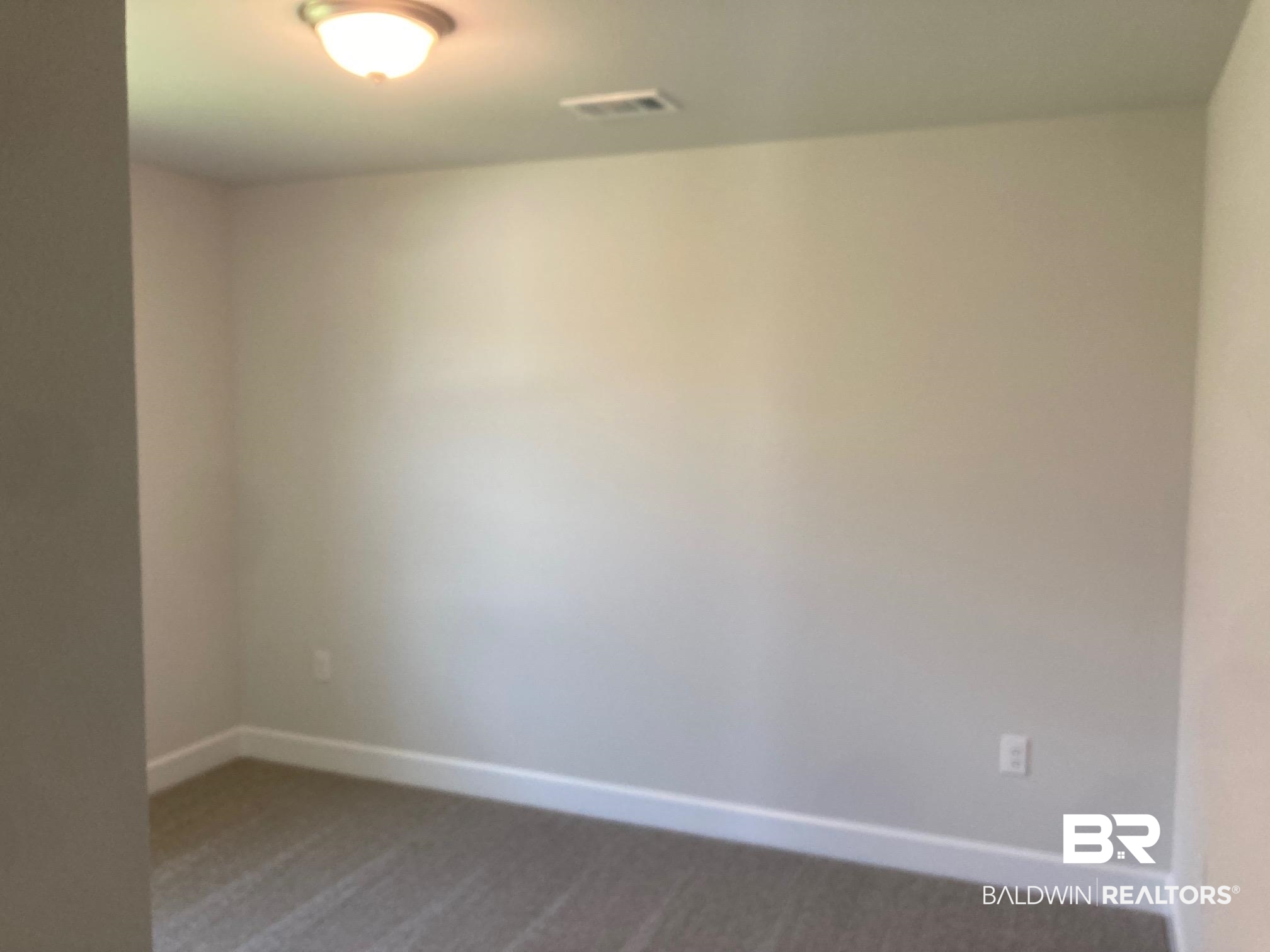 696 Mayflower Drive Foley, AL 36535 - Photo 18 of 25 Unfurnished room featuring carpet floors and baseboards
