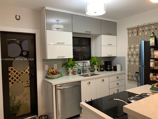2 Northeast 44th Street Miami, FL 33137 - Photo 14 of 25 a kitchen with a sink cabinets and appliances