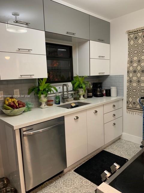 2 Northeast 44th Street Miami, FL 33137 - Photo 15 of 25 a kitchen with white cabinets and appliances