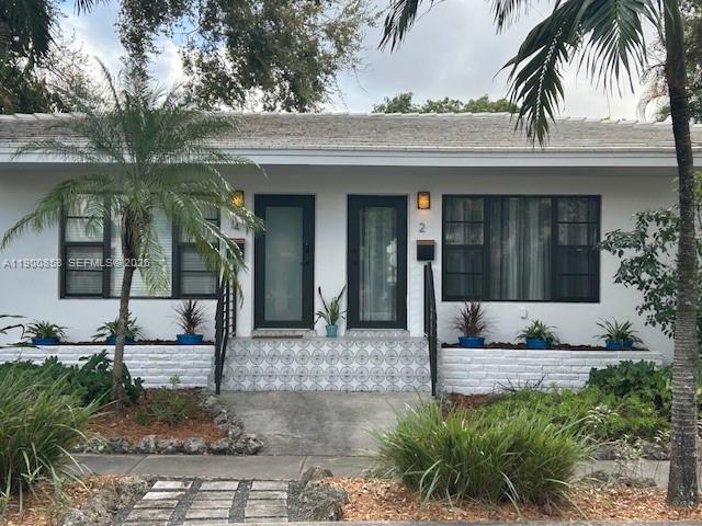 2 Northeast 44th Street Miami, FL 33137 - Photo 2 of 25 a front view of a house with garden