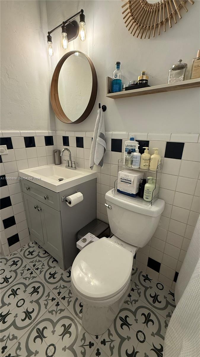 2 Northeast 44th Street Miami, FL 33137 - Photo 23 of 25 a bathroom with a sink a toilet and a mirror
