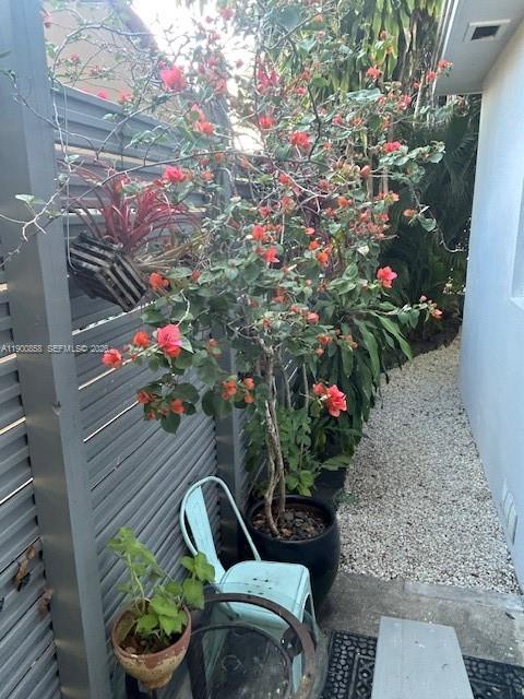 2 Northeast 44th Street Miami, FL 33137 - Photo 24 of 25 a front view of a house with lots of flowers and trees