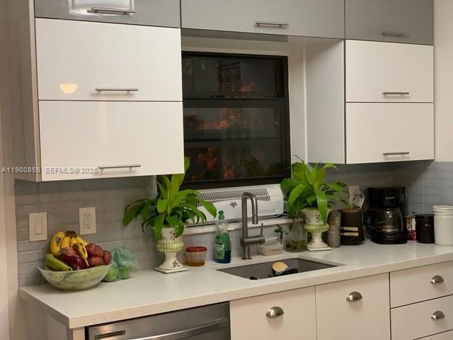 2 Northeast 44th Street Miami, FL 33137 - Photo 7 of 25 a kitchen with a potted plant on the counter and cabinets