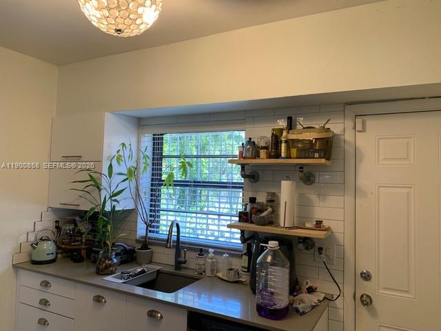 2 Northeast 44th Street Miami, FL 33137 - Photo 8 of 25 a view of a workspace with furniture and a window