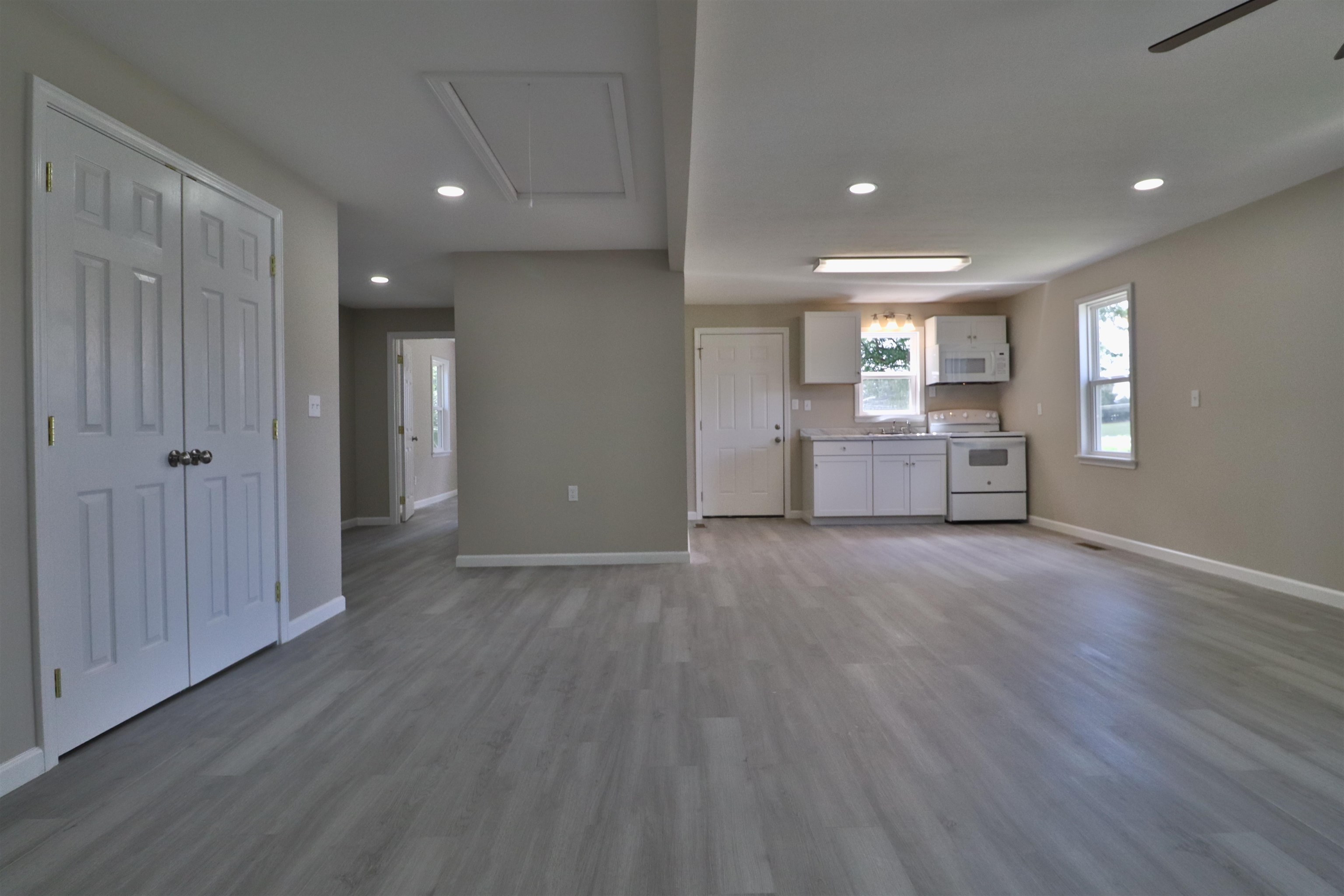 224 Kellar Avenue Ripley, TN 38063 - Photo 5 of 30 an empty room with wooden floor and windows