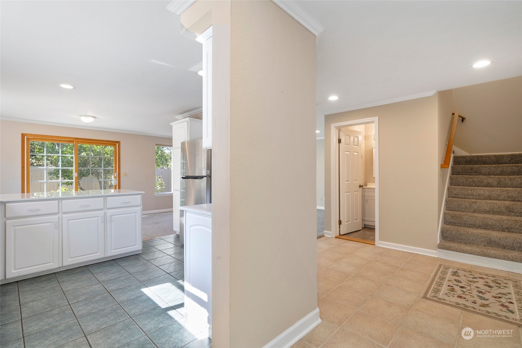 1506 227th Place Southwest Bothell, WA 98021 - Photo 11 of 25 a view of a kitchen with white cabinets and wooden floor