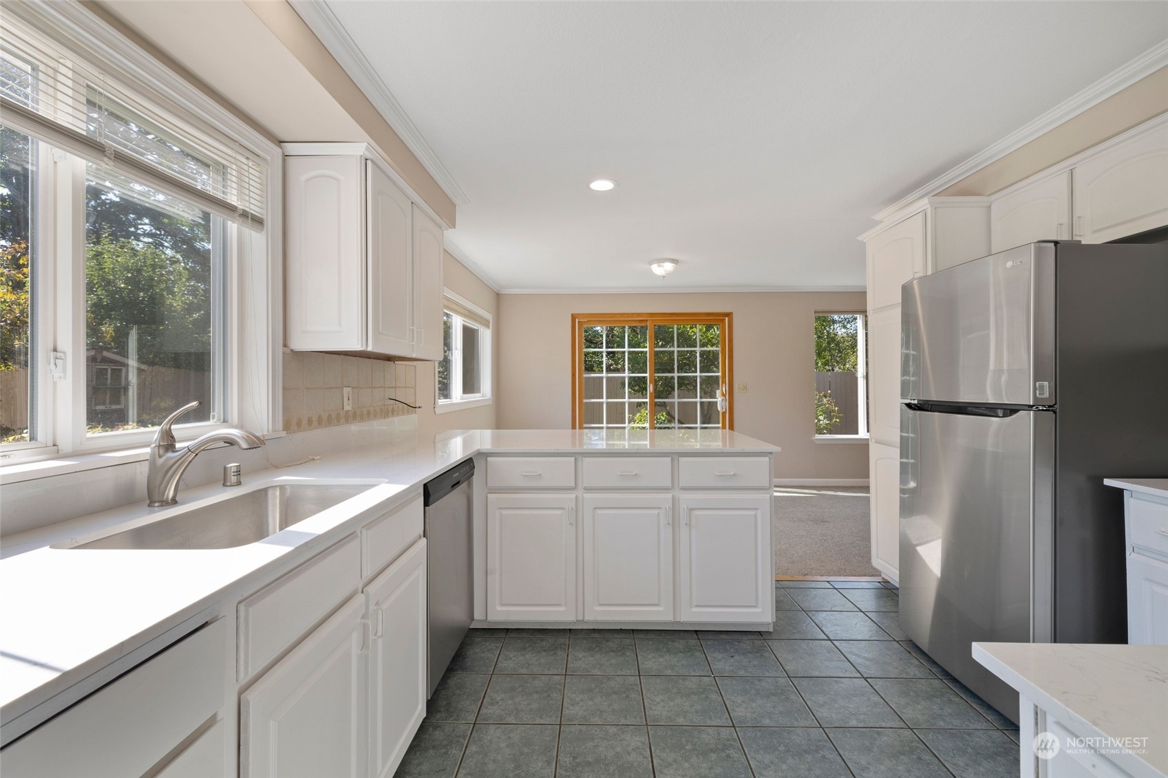 1506 227th Place Southwest Bothell, WA 98021 - Photo 7 of 25 a kitchen with white cabinets and a refrigerator