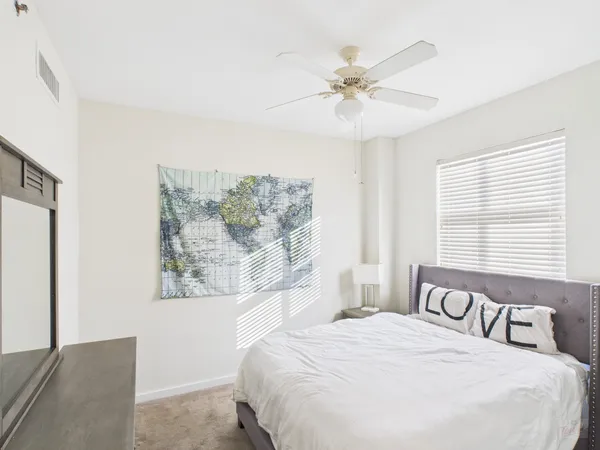 a bedroom with a large bed and a chandelier