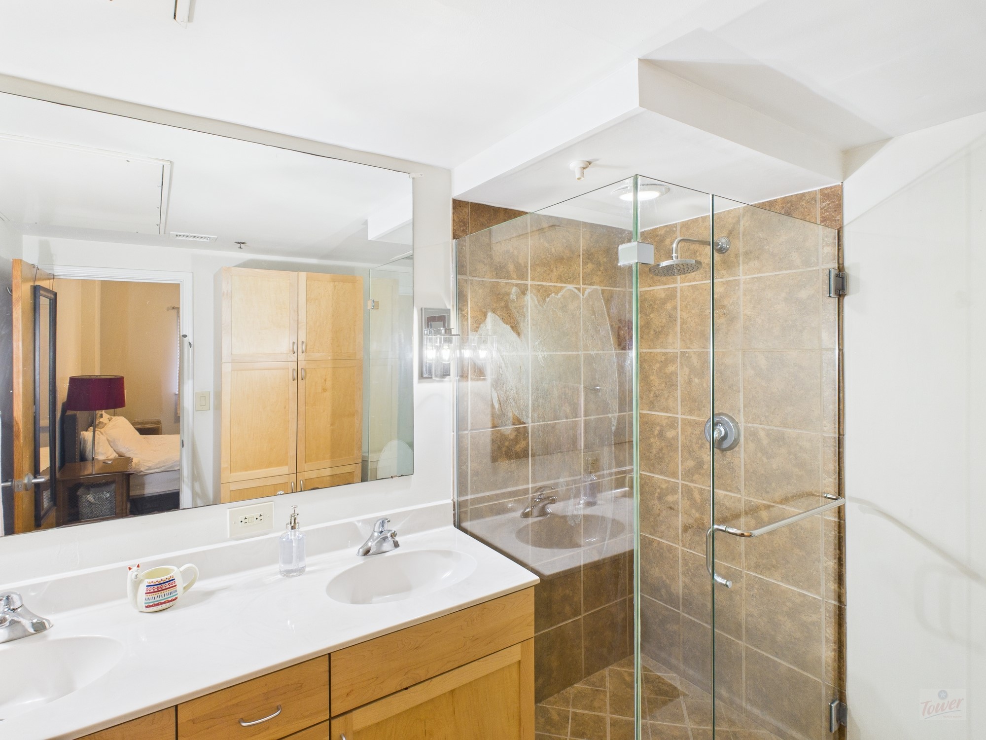 711 West 26th Street, Unit 606 Austin, TX 78705 - Photo 8 of 11 a bathroom with a shower sink and mirror