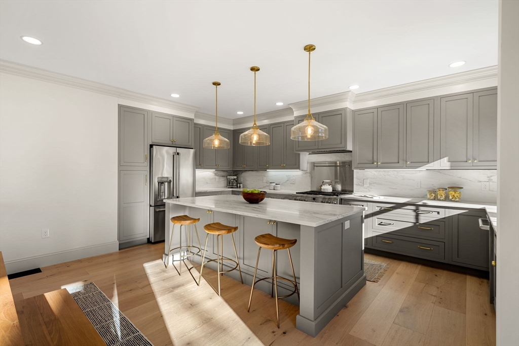 7 Flatley Avenue Manchester, MA 01944 - Photo 11 of 42 a kitchen with stainless steel appliances granite countertop a sink a stove and a refrigerator